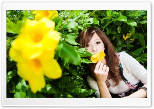 Woman Smelling A Flower