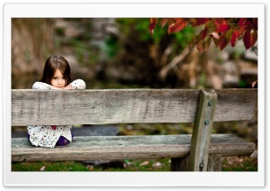 Child Sitting On A Bench