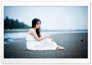 Girl Sitting On The Beach
